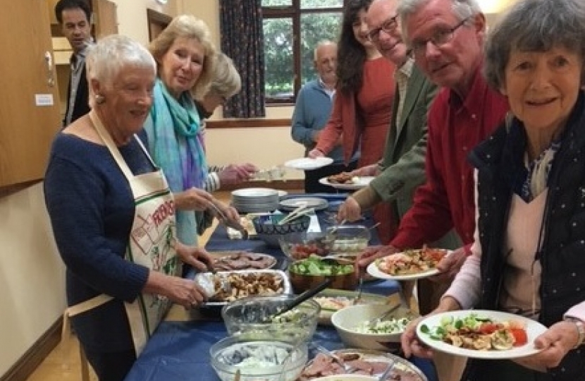 Attendees line up for a buffet lunch